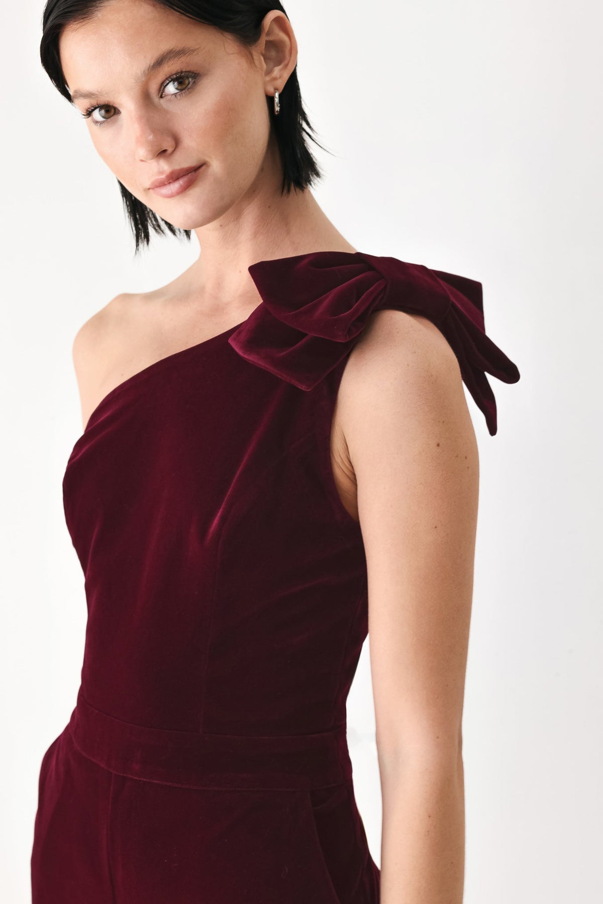 BERRY AFTER DARK VELVET BOW ONE-SHOULDER JUMPSUIT