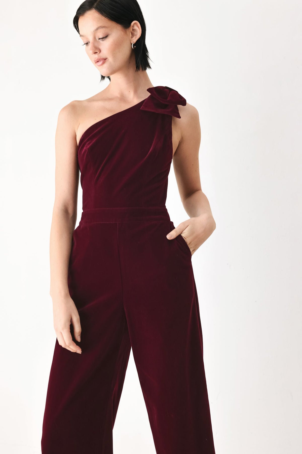 BERRY AFTER DARK VELVET BOW ONE-SHOULDER JUMPSUIT